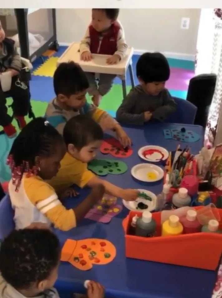 Children participating in a colorful classroom painting activity